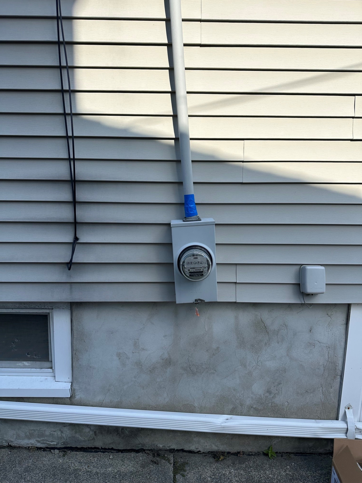 Boston Light & Power electrician installing a new electric meter base and service conduit on a home exterior in Weymouth, MA.